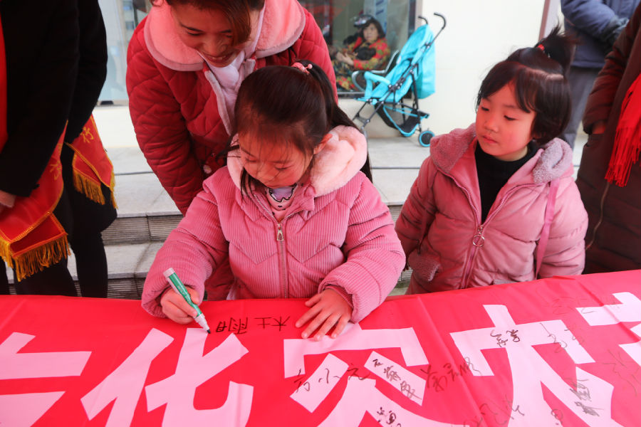 小朋友在“万人签名”横幅上签名.JPG